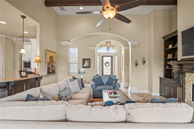 a living room with furniture and a chandelier
