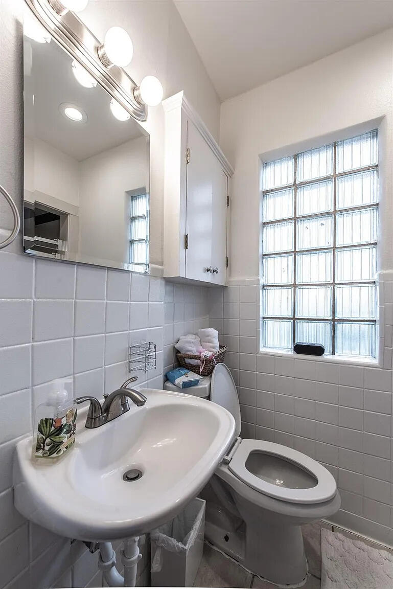 3105 29th Street Lubbock, TX 79410 - Photo 8 of 18 a bathroom with a sink and a toilet