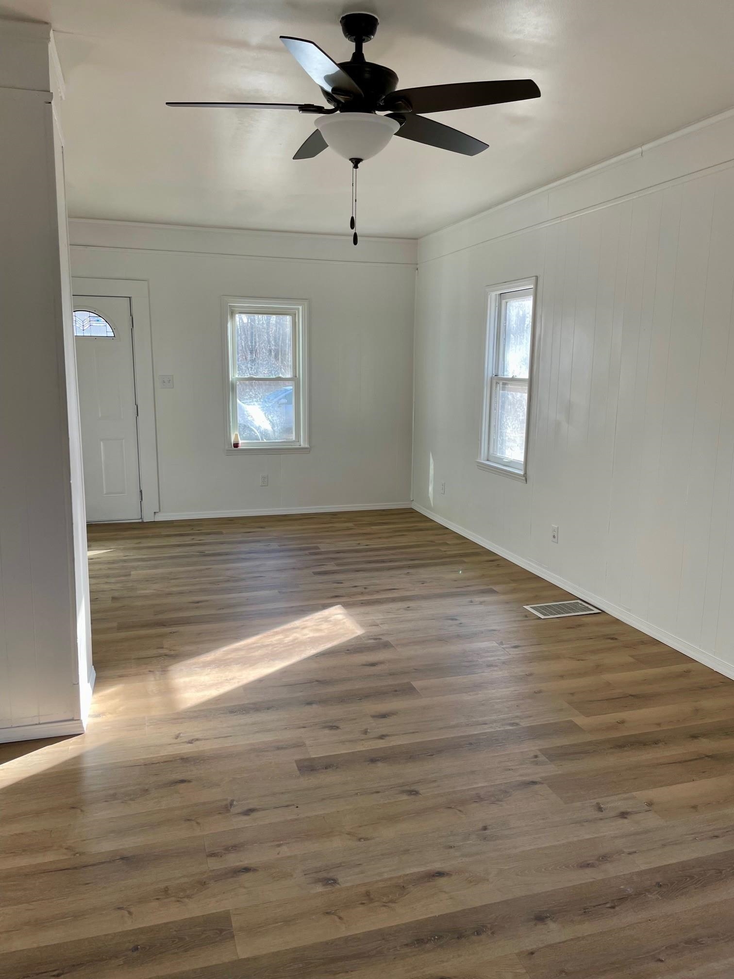 106 Ravine Street Spring Valley, IL 61362 - Photo 3 of 7 a view of empty room with wooden floor and fan