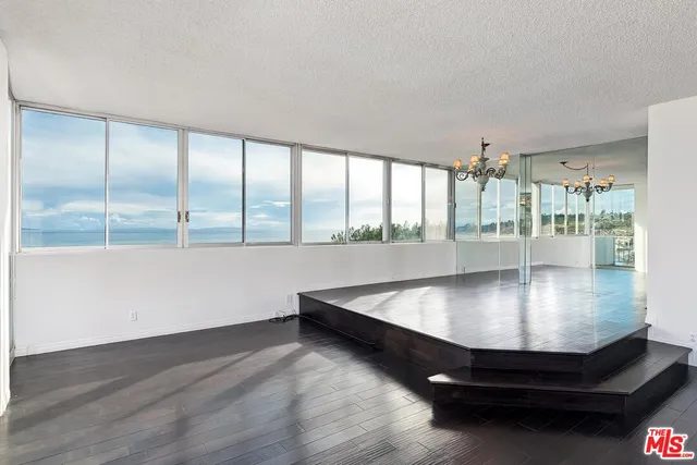 a view of a room with wooden floor