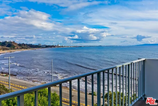 a kitchen with granite countertop a stove a sink and a refrigerator