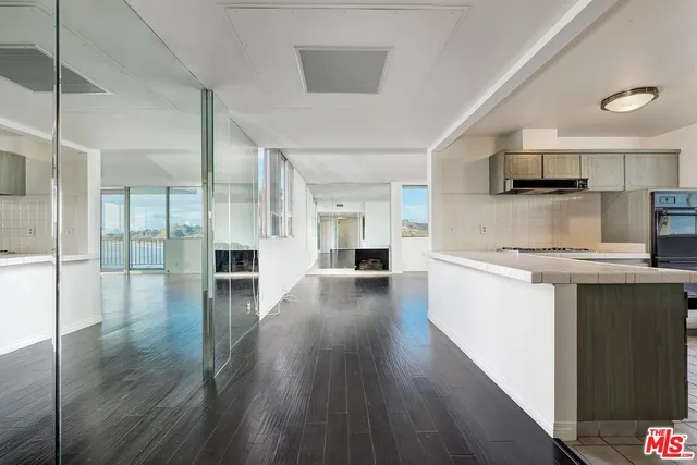 a kitchen with granite countertop a sink and a stove top oven