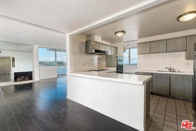 a kitchen with a sink cabinets and appliances