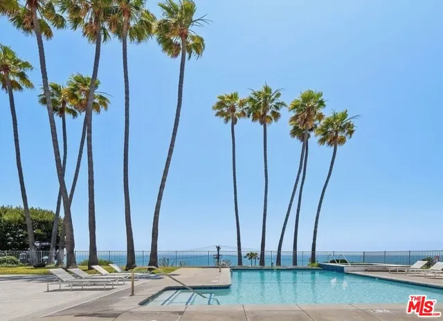 a view of a patio with table and chairs potted plants with wooden floor