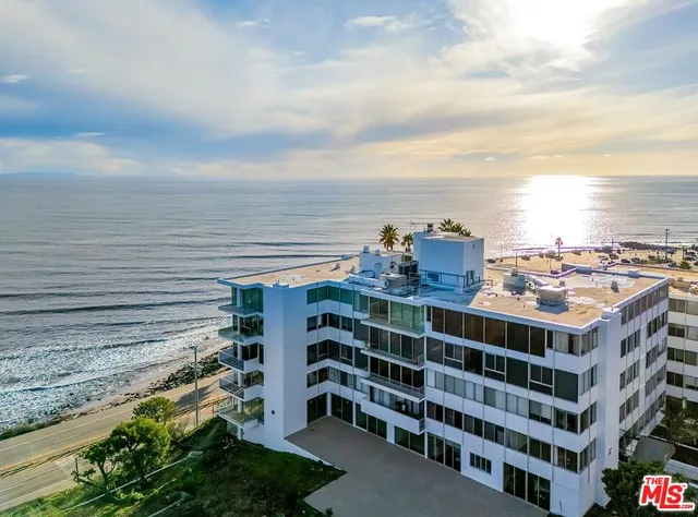 a living room with hardwood floor and a large window