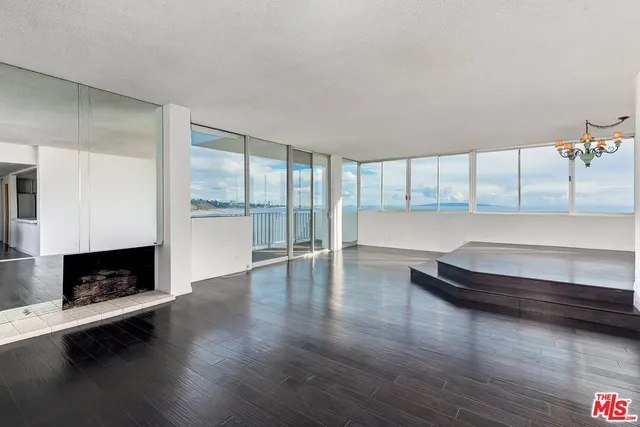a living room with hard wood floors and a window