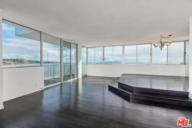 a room with wooden floor and large window