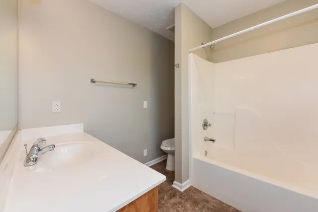 a bathroom with a bathtub and a toilet