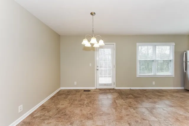 an empty room with windows and entrance