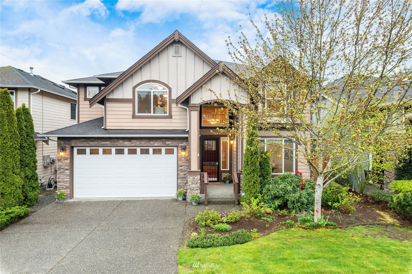 3710 222nd Place Southeast Bothell, WA 98021 - Photo 1 of 37 a front view of a house with a yard and garage