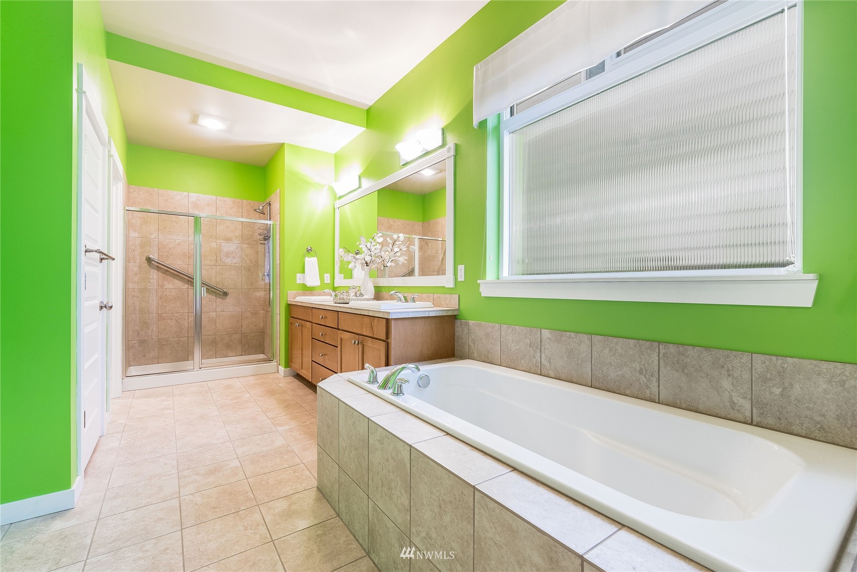 3710 222nd Place Southeast Bothell, WA 98021 - Photo 13 of 37 a bathroom with a tub a sink and a large mirror