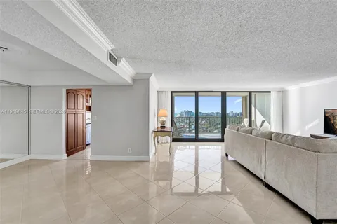 a living room with furniture and large windows