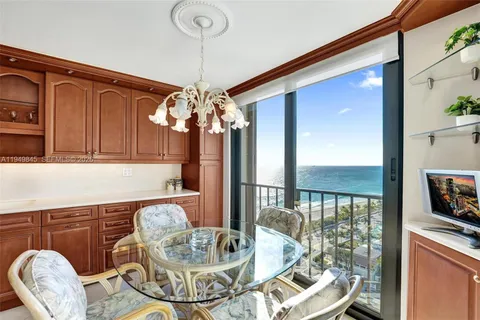 a dining room with furniture and chandelier