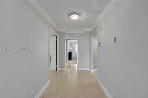 a view of a hallway with wooden shelves