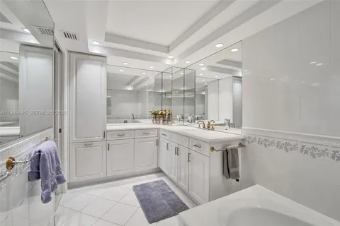 a spacious bathroom with a sink mirror and a shower