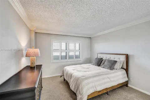 a bedroom with a bed lamps and window