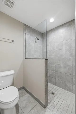 a bathroom with a toilet and a shower