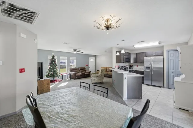 a living room with furniture and kitchen view