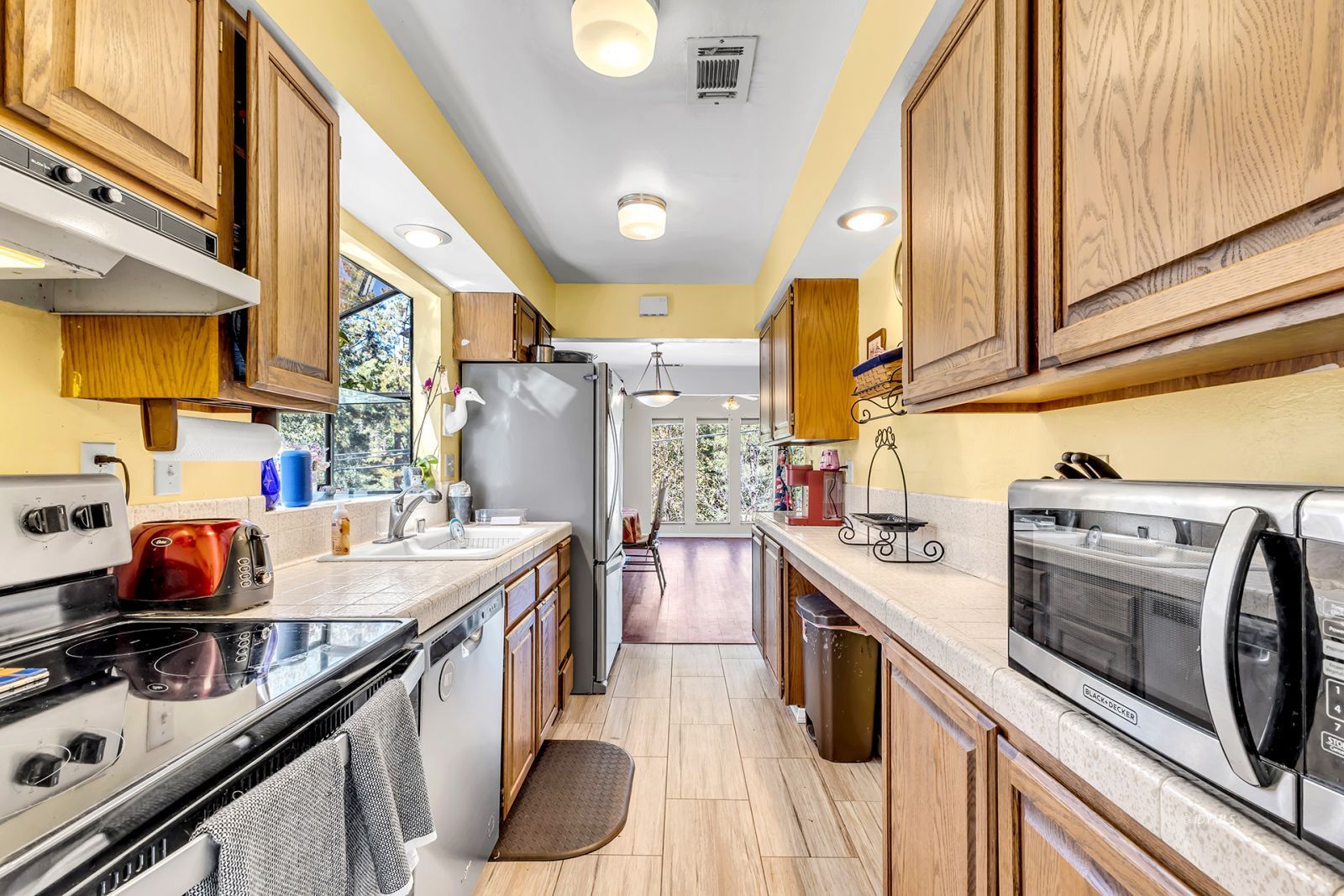 53575 Tollgate Road Idyllwild, CA 92549 - Photo 35 of 71 a kitchen with stainless steel appliances granite countertop a sink stove and refrigerator