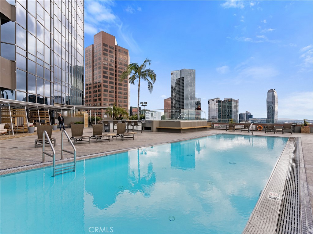 a view of swimming pool with outdoor seating and city view