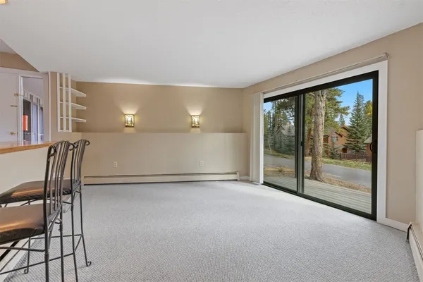 a view of an empty room with a fireplace and a window