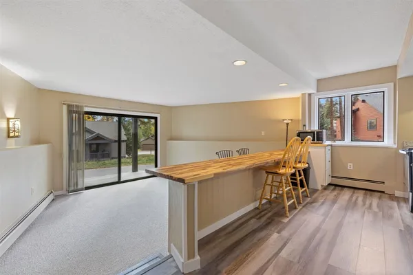 a view of a room with wooden floor and furniture