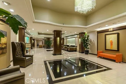 a lobby with furniture and a chandelier