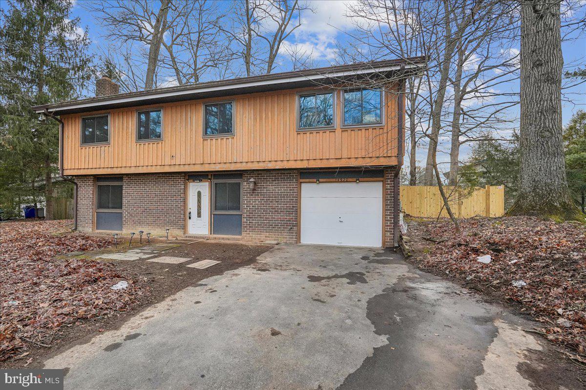 14920 Chestnut Ridge Court North Potomac, MD 20878 - Photo 1 of 32 a front view of a house with a yard and garage