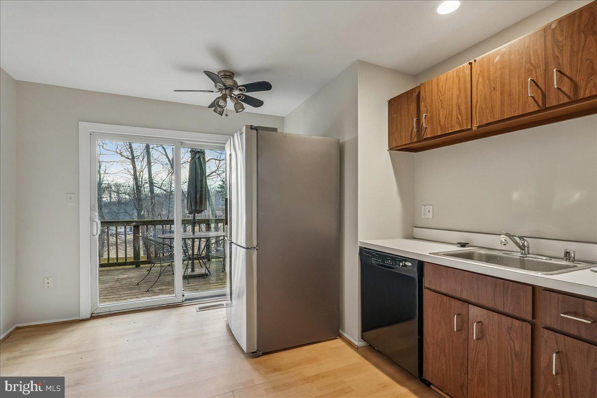 14920 Chestnut Ridge Court North Potomac, MD 20878 - Photo 11 of 32 a kitchen with stainless steel appliances granite countertop a refrigerator a sink and dishwasher