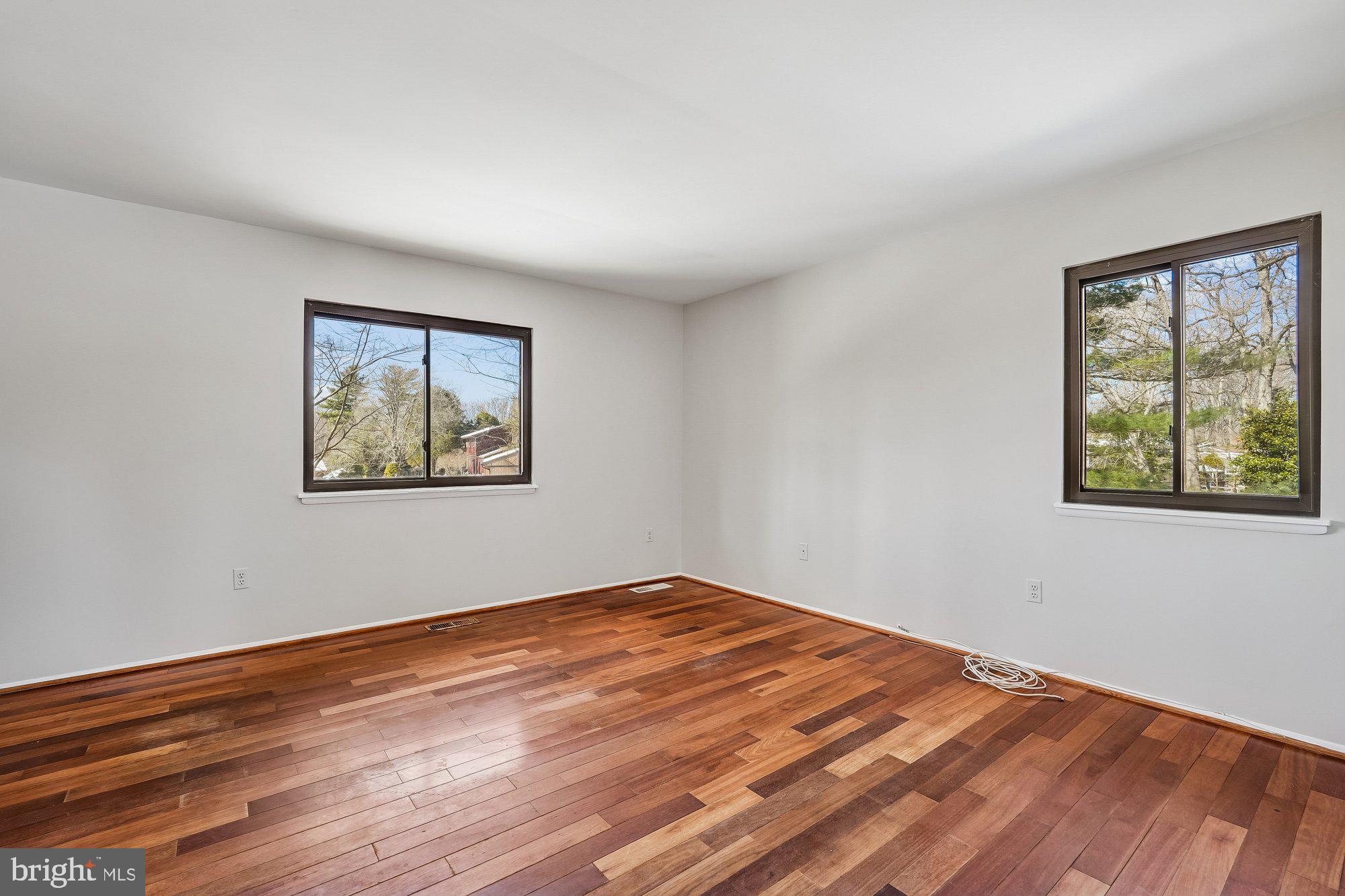 14920 Chestnut Ridge Court North Potomac, MD 20878 - Photo 13 of 32 a view of empty room with wooden floor and fan