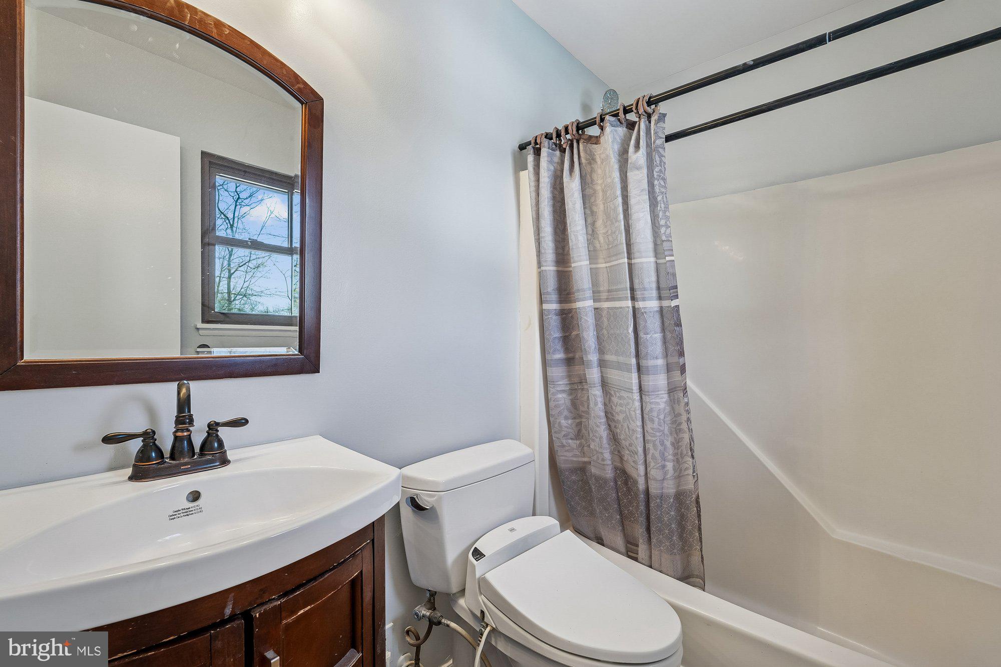 14920 Chestnut Ridge Court North Potomac, MD 20878 - Photo 14 of 32 a bathroom with a sink toilet and shower