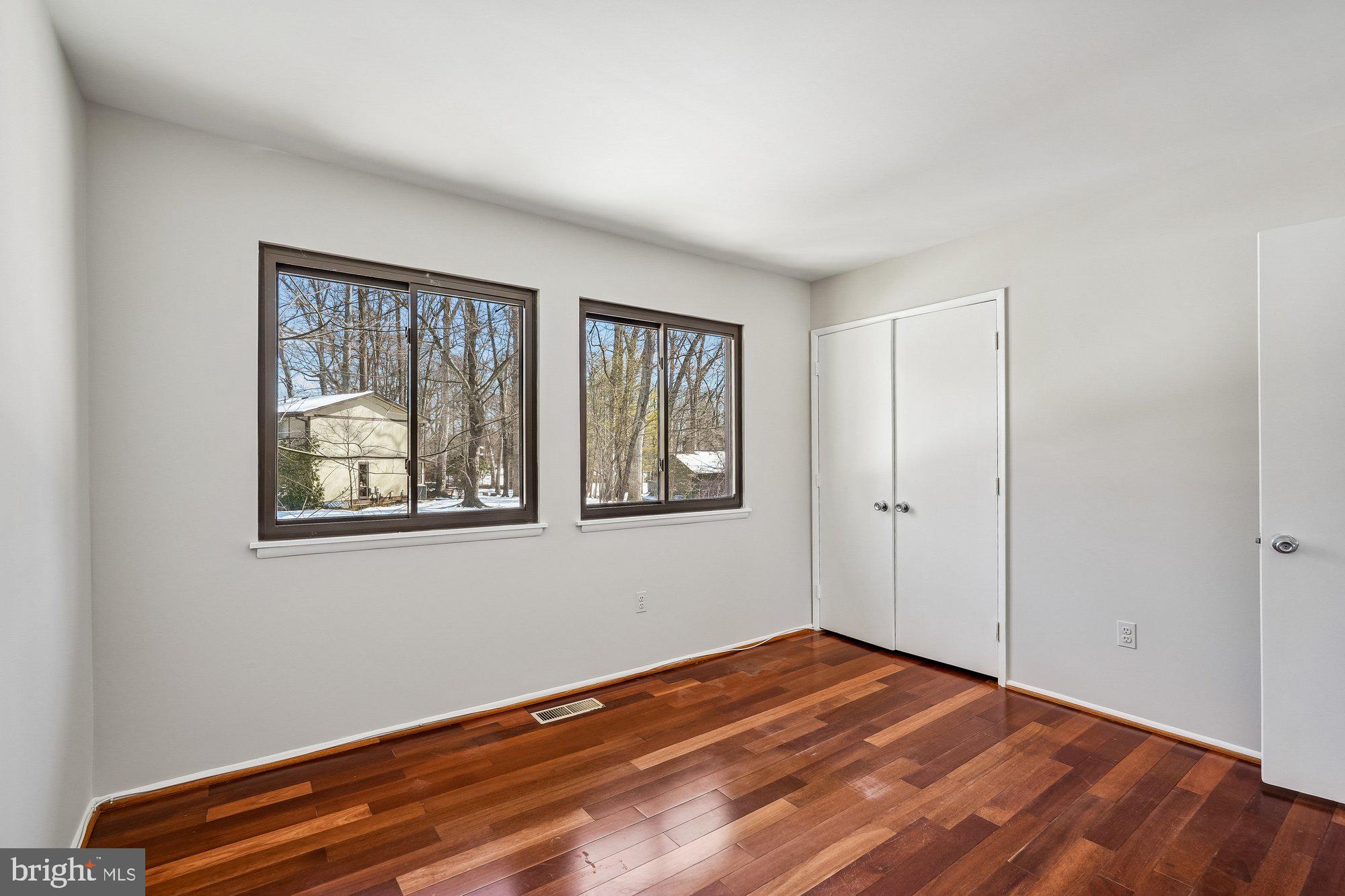 14920 Chestnut Ridge Court North Potomac, MD 20878 - Photo 16 of 32 a view of an empty room with window and wooden floor