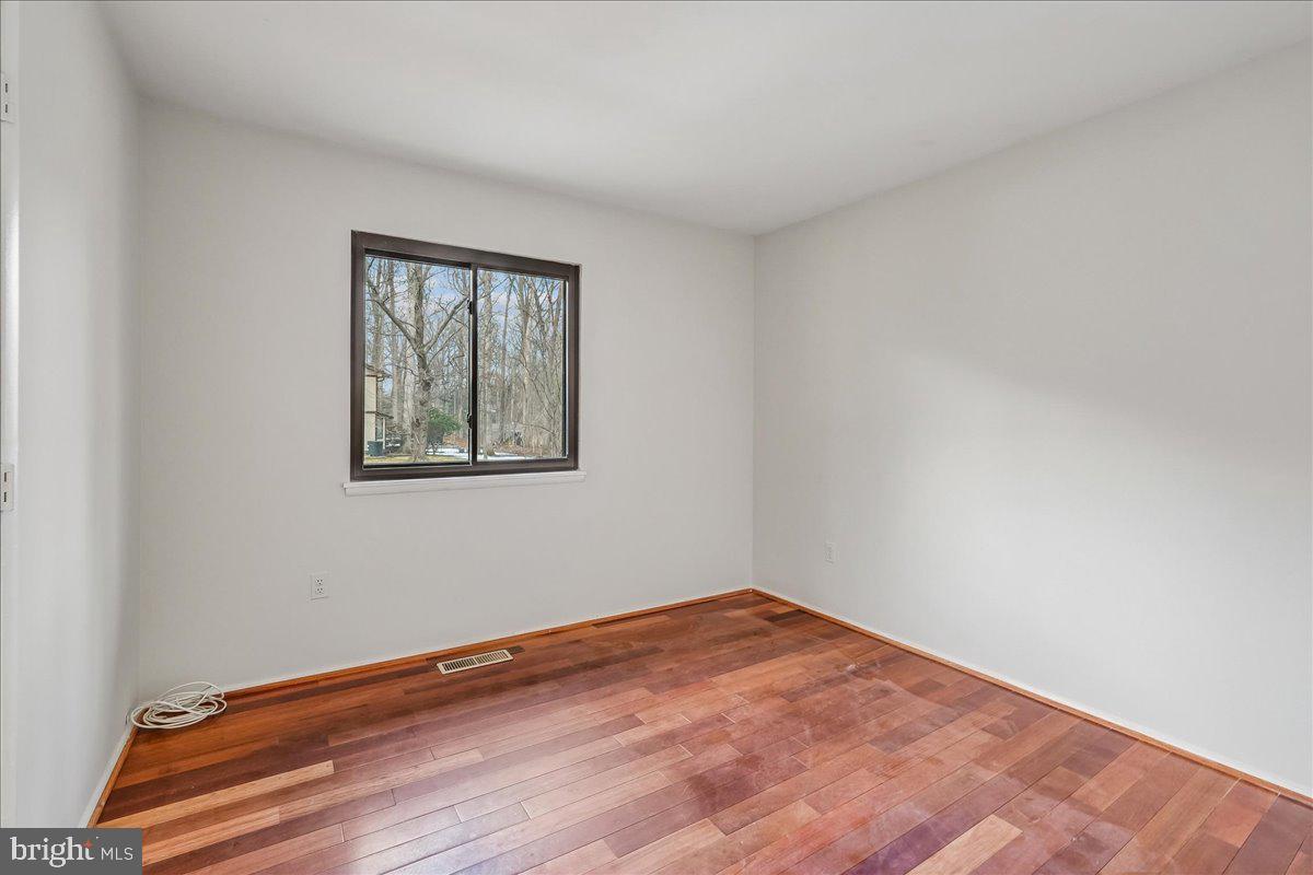 14920 Chestnut Ridge Court North Potomac, MD 20878 - Photo 17 of 32 a view of empty room with wooden floor