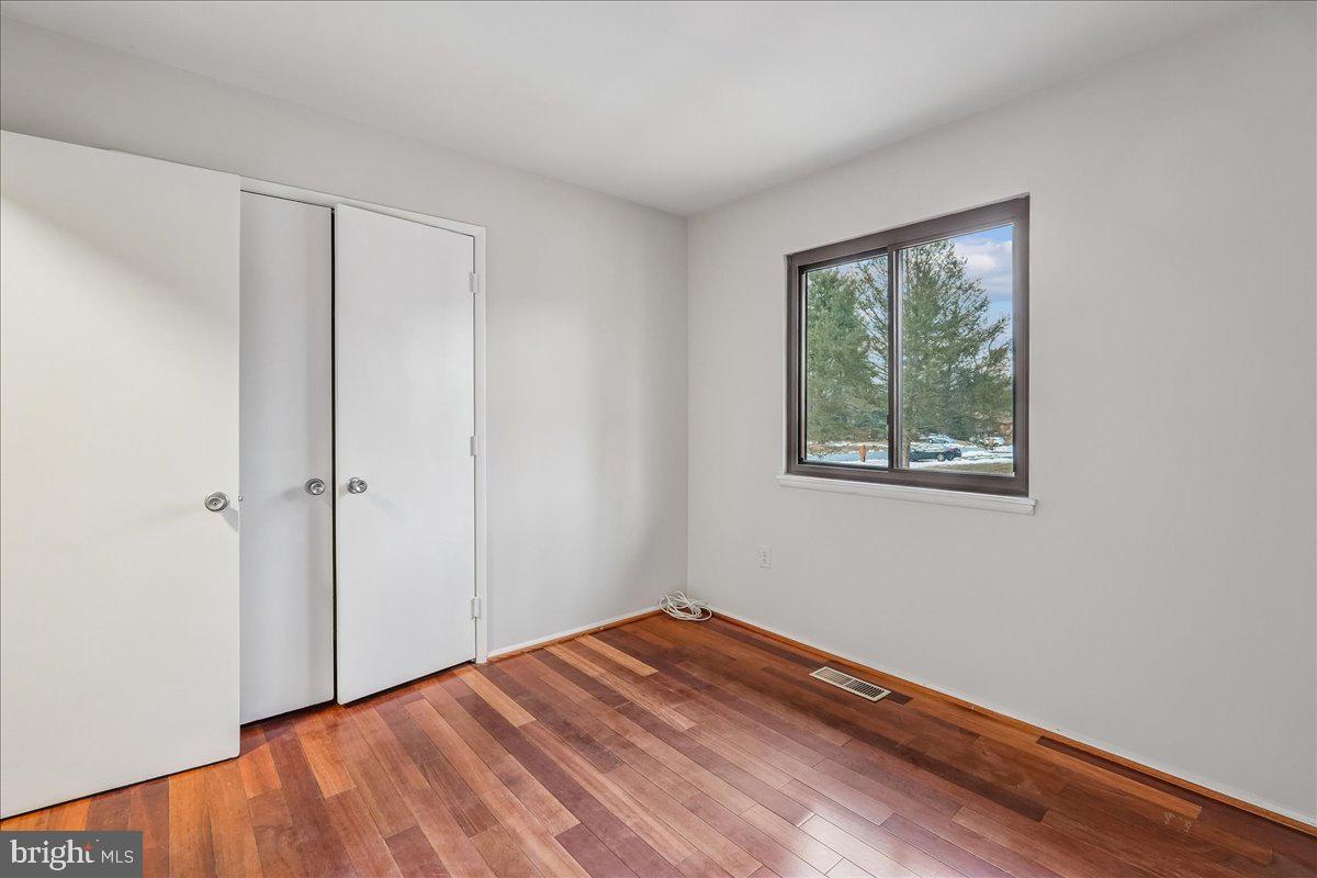 14920 Chestnut Ridge Court North Potomac, MD 20878 - Photo 18 of 32 a view of empty room with wooden floor and fan