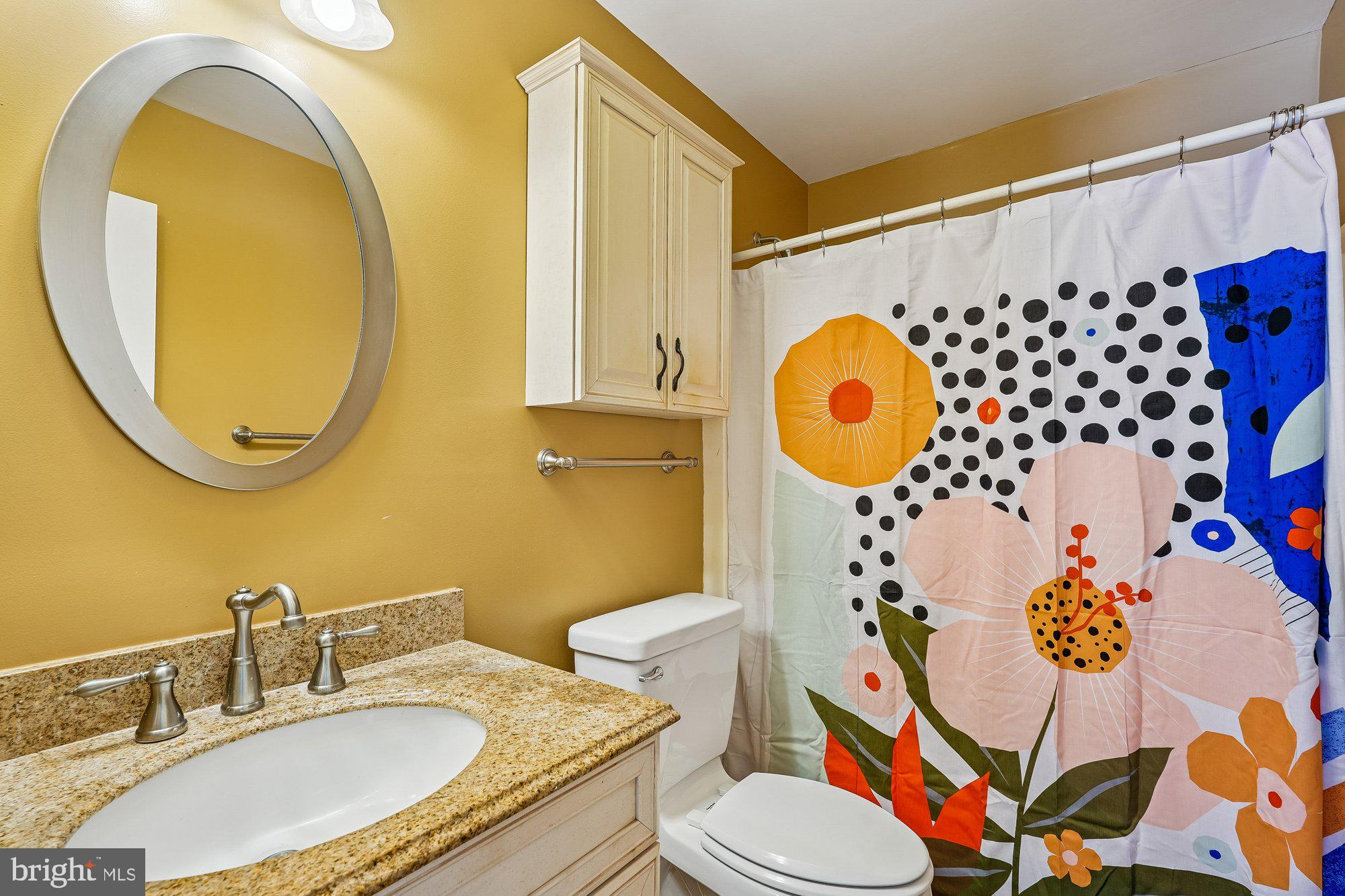 14920 Chestnut Ridge Court North Potomac, MD 20878 - Photo 19 of 32 a bathroom with a mirror sink and a mirror