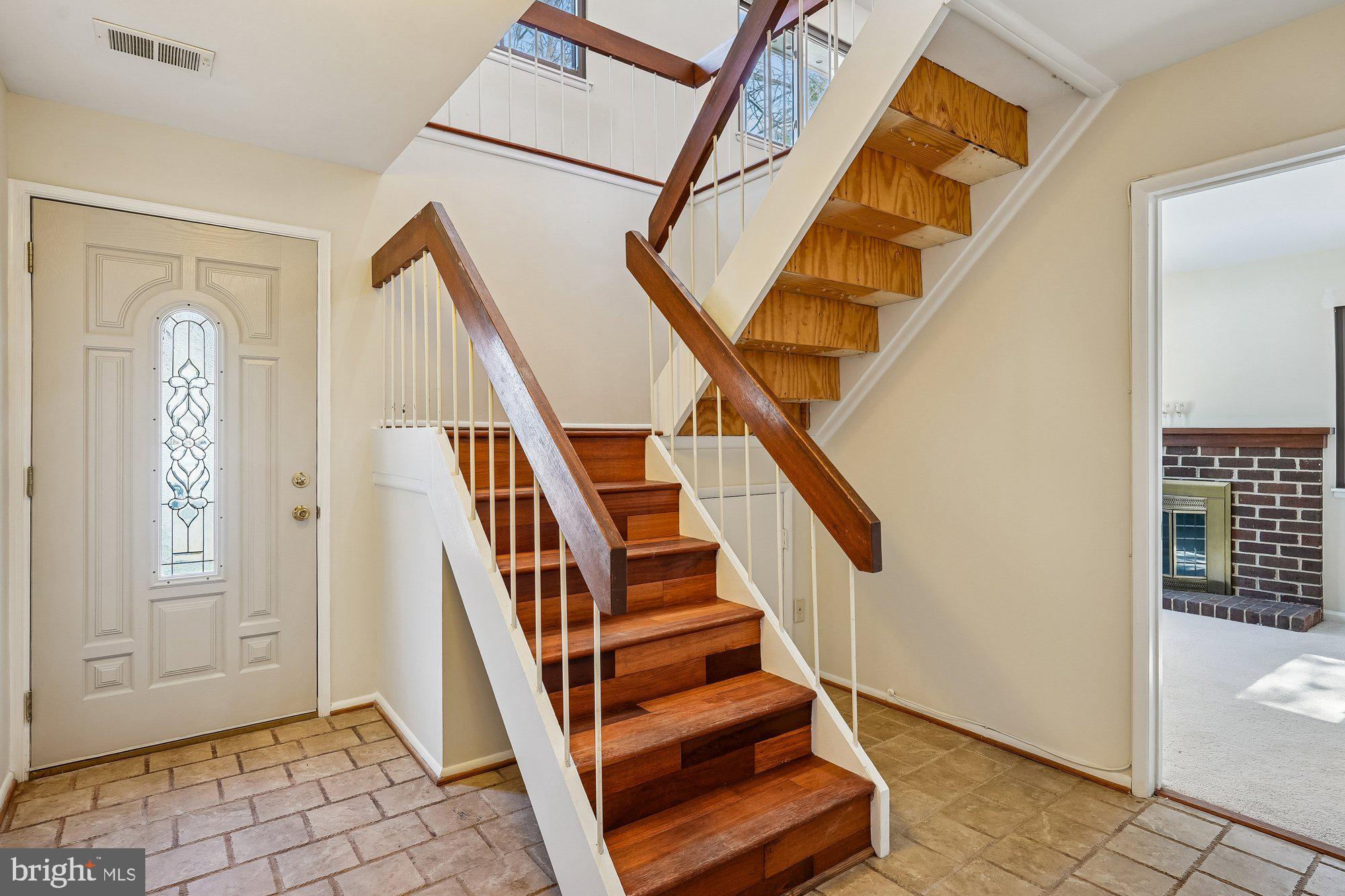 14920 Chestnut Ridge Court North Potomac, MD 20878 - Photo 2 of 32 a view of entryway with wooden floor and stairs