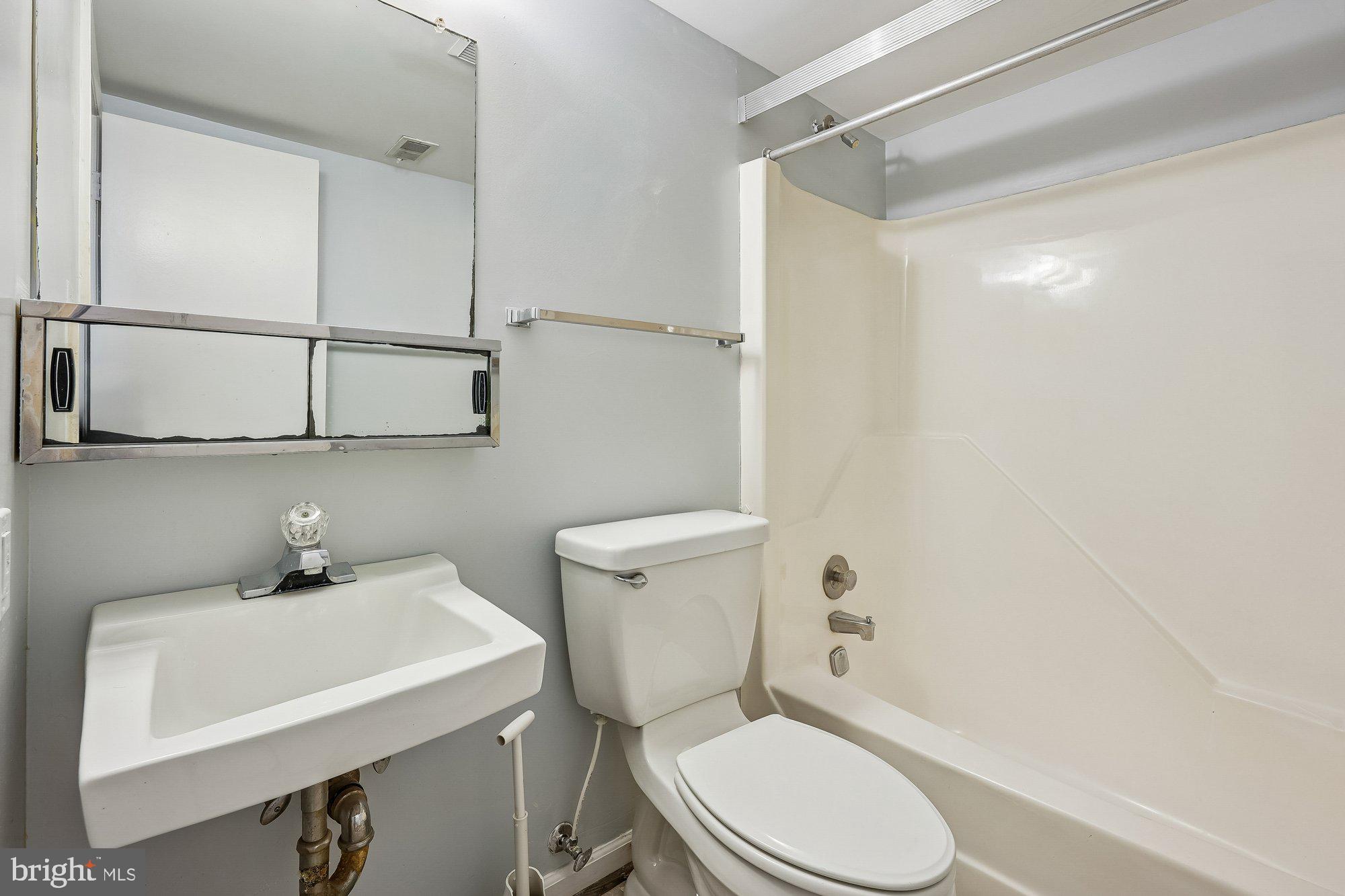 14920 Chestnut Ridge Court North Potomac, MD 20878 - Photo 25 of 32 a white toilet sitting next to a bathroom sink