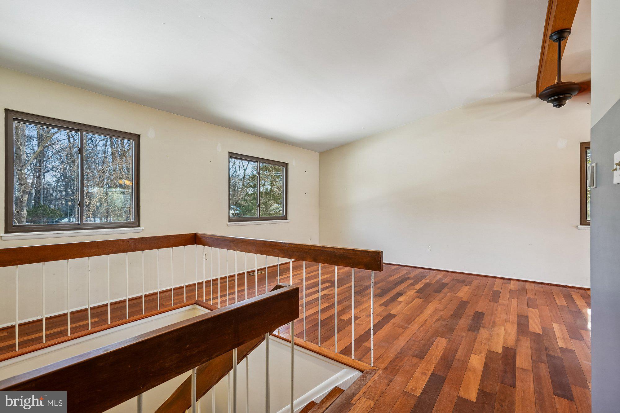 14920 Chestnut Ridge Court North Potomac, MD 20878 - Photo 3 of 32 a view of a bedroom with wooden floor and a window