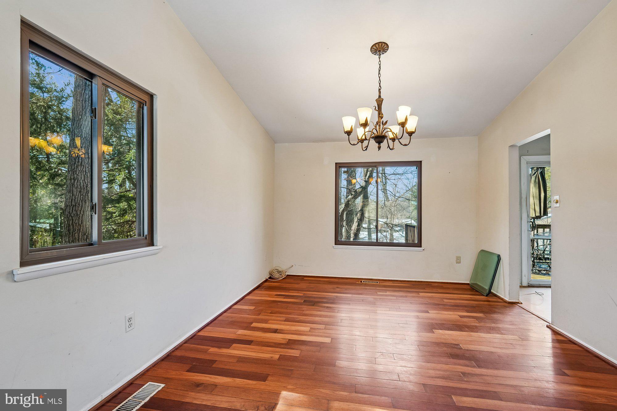 14920 Chestnut Ridge Court North Potomac, MD 20878 - Photo 6 of 32 a view of a room with wooden floor chandelier and windows