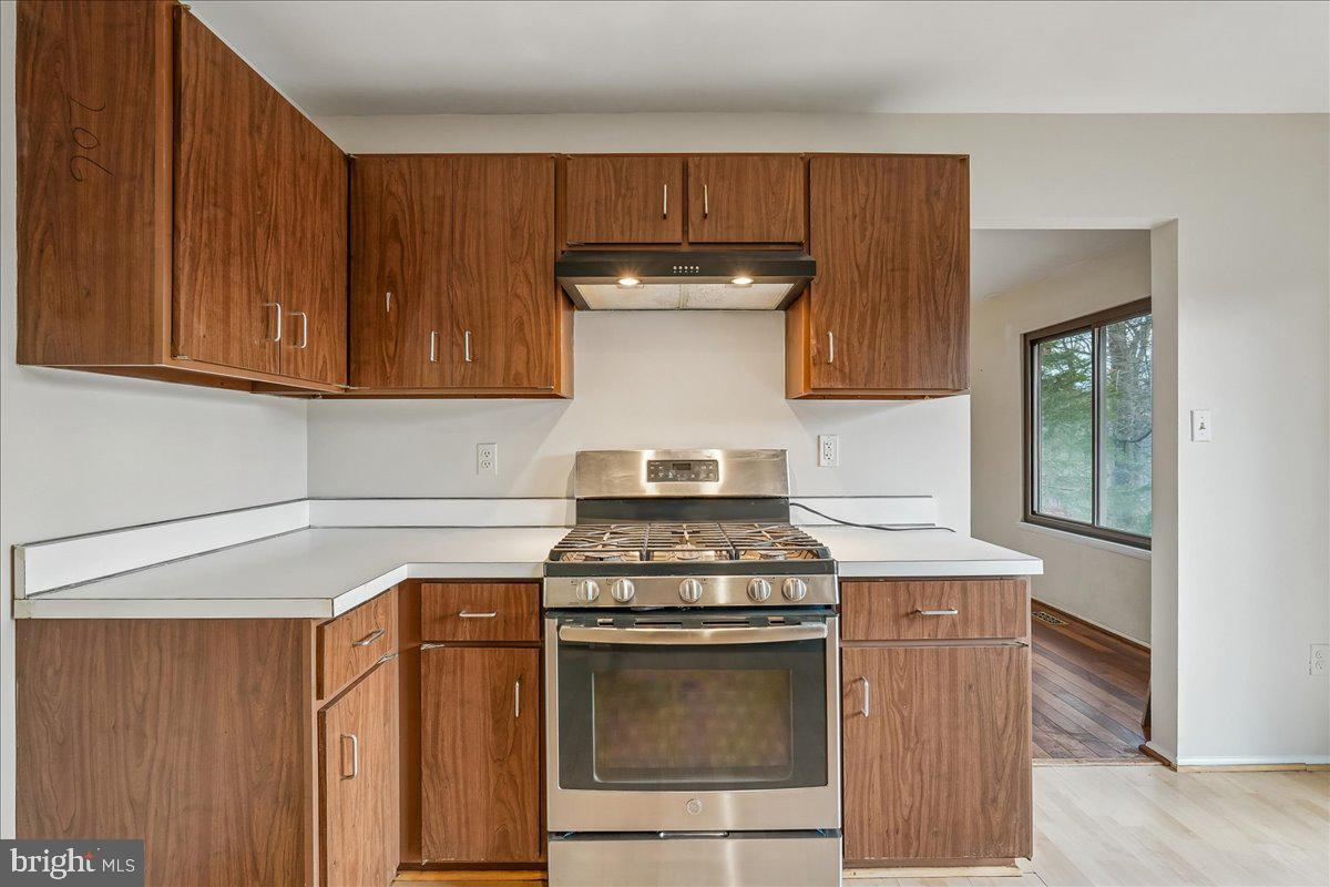 14920 Chestnut Ridge Court North Potomac, MD 20878 - Photo 10 of 32 a kitchen with granite countertop wood cabinets and stainless steel appliances