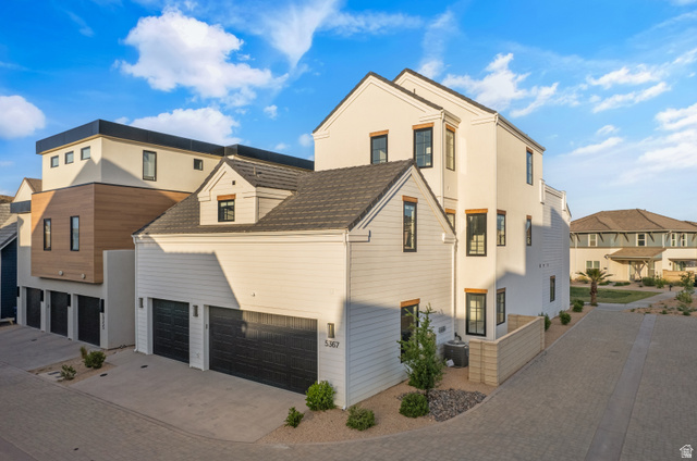 5367 Cyan Lane St. George, UT 84790 - Photo 16 of 49 Contemporary multi-level exterior with a two-car garage, dormer window, black framed windows, and a combination of horizontal siding and smooth stucco finishes