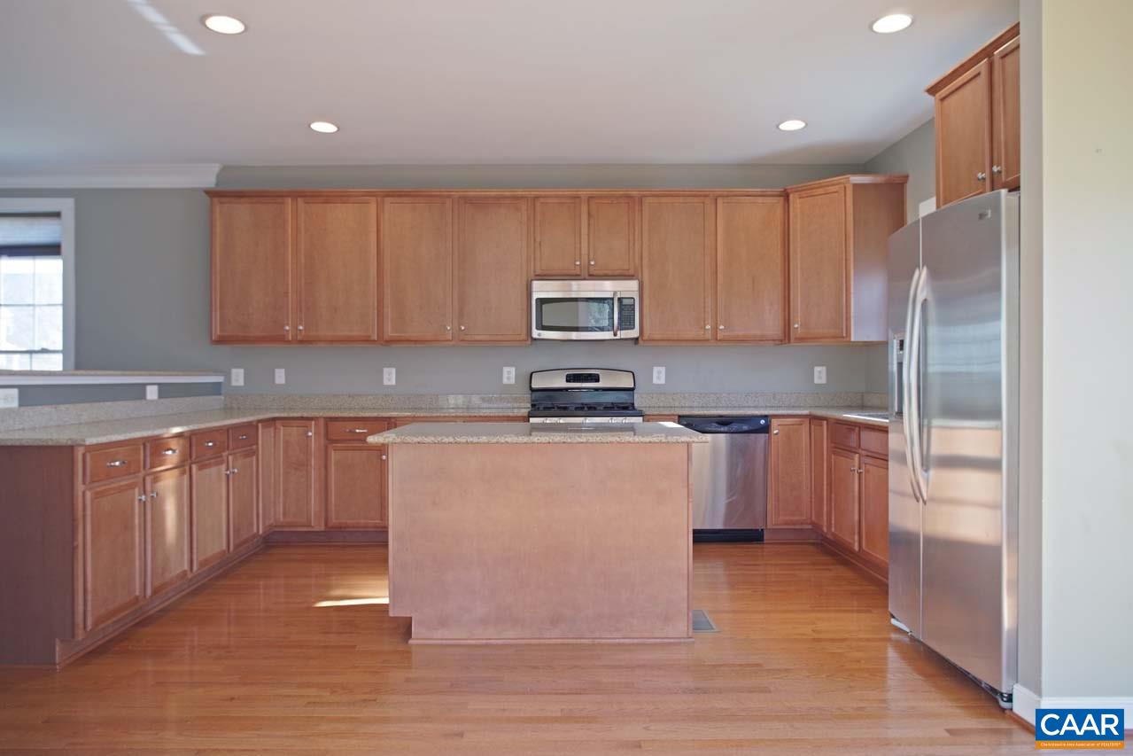 5477 Park Road Crozet, VA 22932 - Photo 12 of 47 a kitchen with granite countertop a refrigerator stove top oven and wooden floor