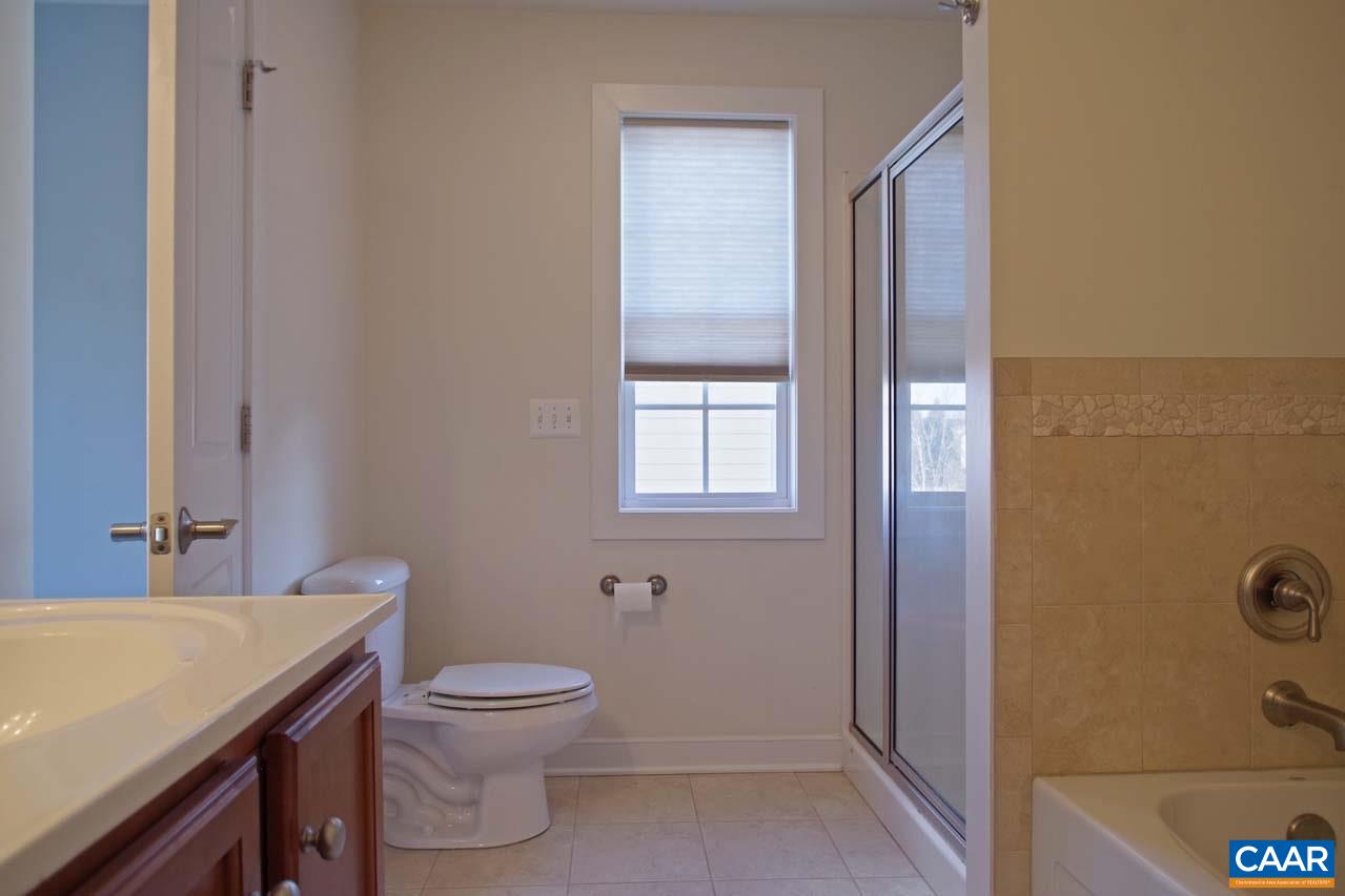 5477 Park Road Crozet, VA 22932 - Photo 24 of 47 a bathroom with a granite countertop toilet a sink and a mirror