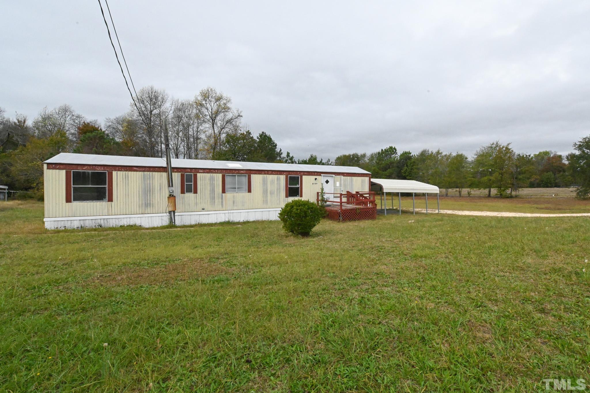 4765 Baileys Crossroads Road Coats, NC 27521 - Photo 36 of 43 a view of a house with a backyard