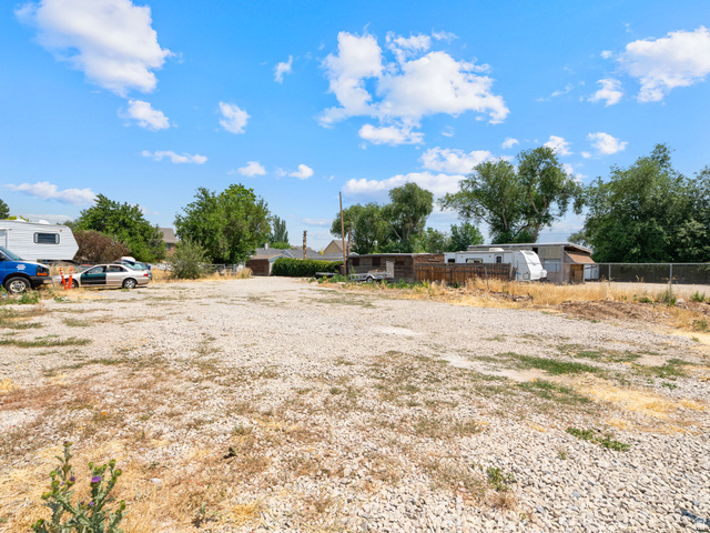 72 Cox Lane Midvale, UT 84047 - Photo 16 of 16 Gravel lot with perimeter fencing and mature trees