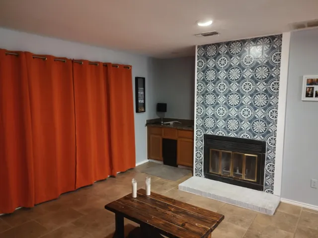 a living room with a fireplace and a fireplace