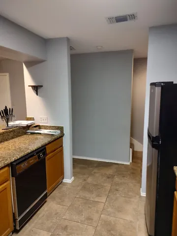 a kitchen with a stove top oven and refrigerator