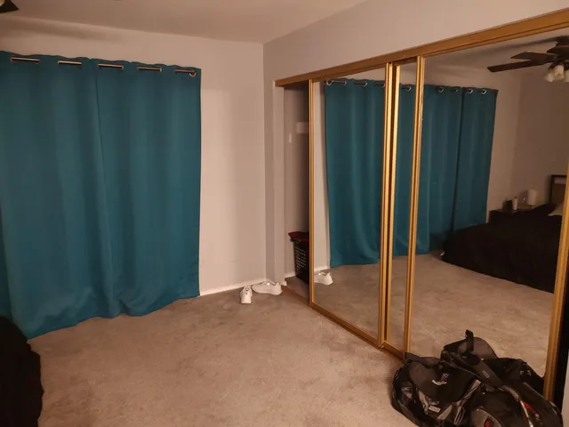 a bed room with a bed and a mirror