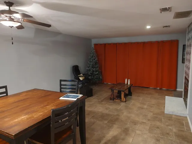 a room with table chairs and a window