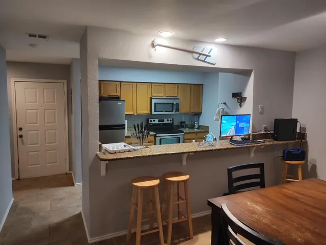 a kitchen with a table and chairs in it